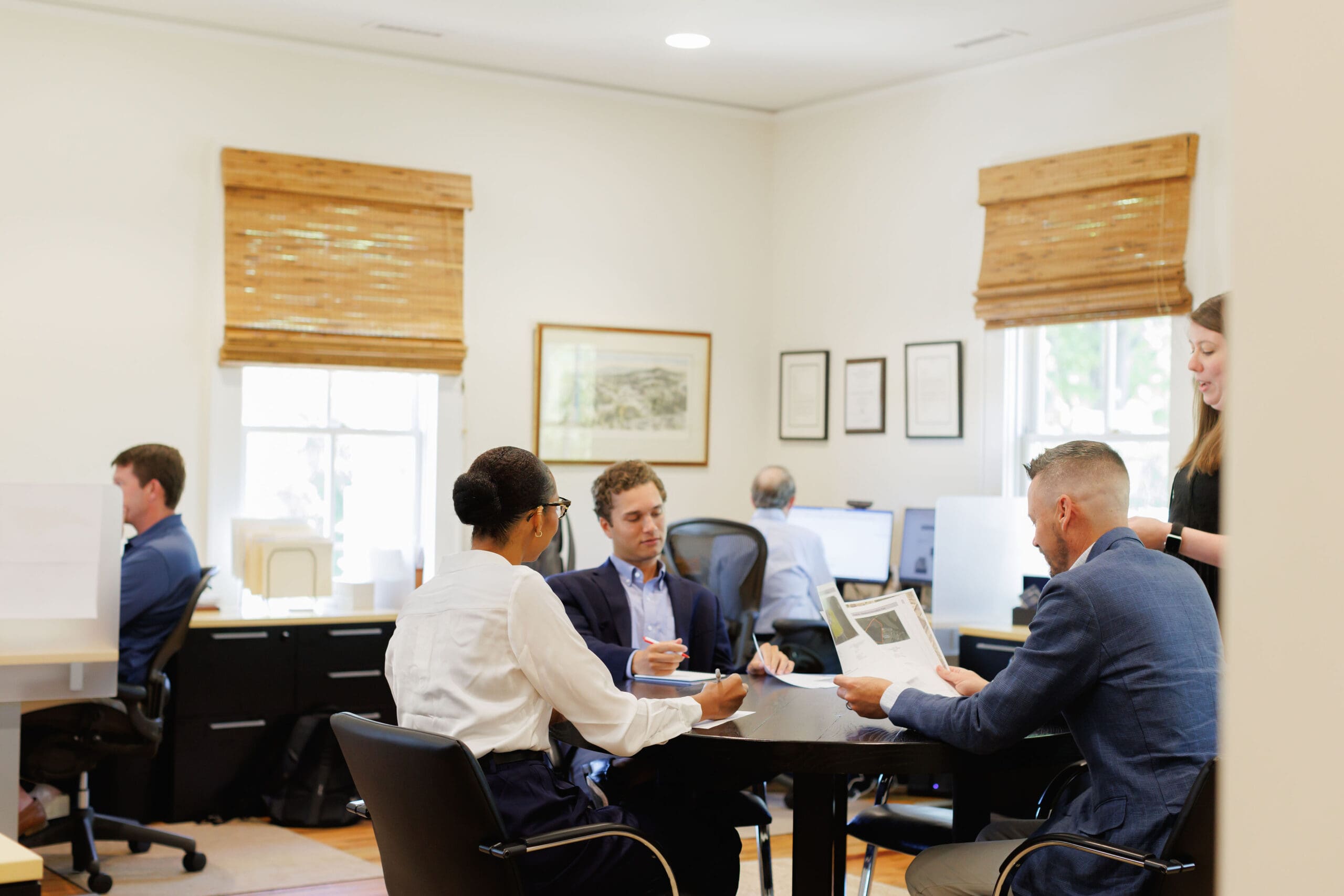 MECA Commercial team members collaborating around a conference table